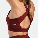 close up view for fit woman wearing bra pomegranate red with logo and designed specials 