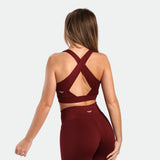 a back view for fit woman wearing matching set bra and  flared legging pomegranate red 