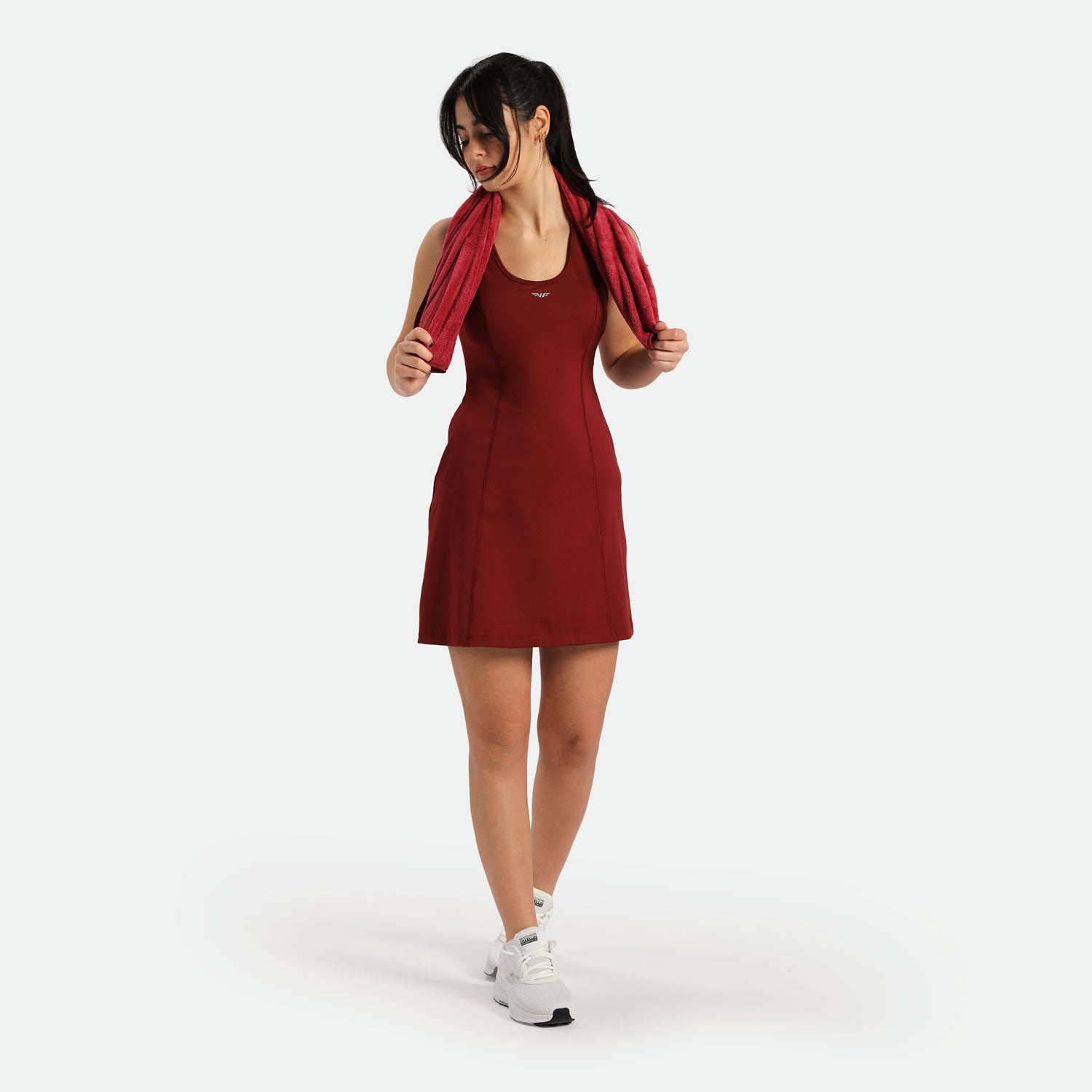 a fit woman wearing dress red with shoes white 