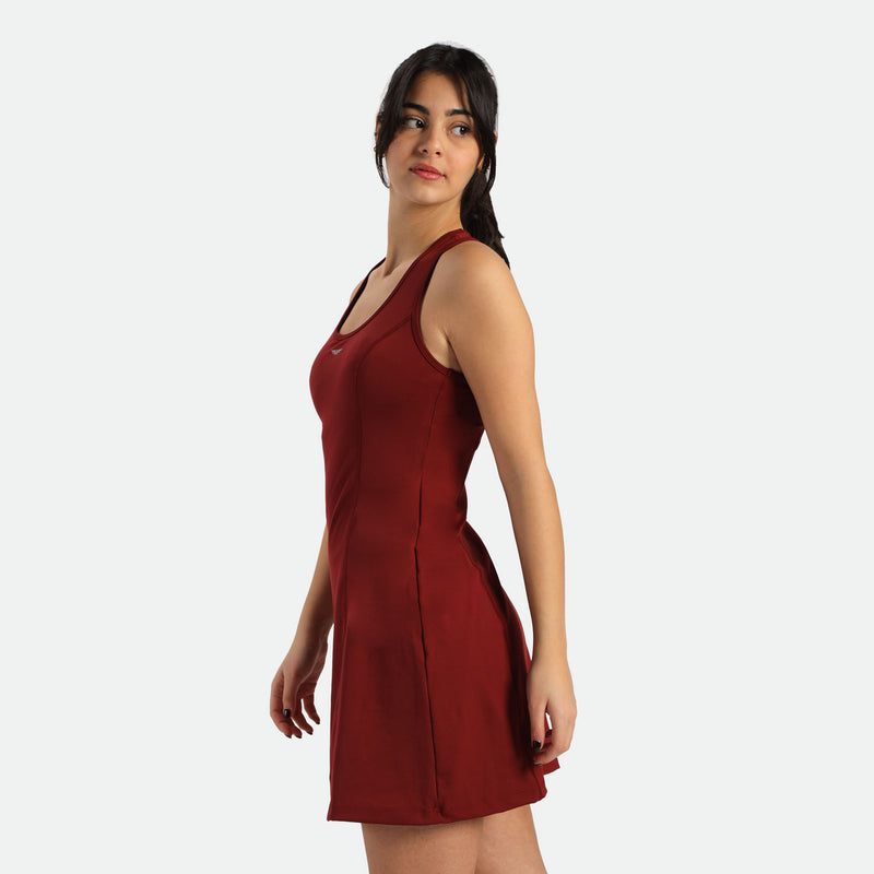 a fit woman stand at right and wearing dress red
