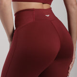 close up view for back view of woman wearing legging pomegranate with logo 