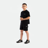 a young boy wearing matching set black ,t-shirt and short ,plus shoes