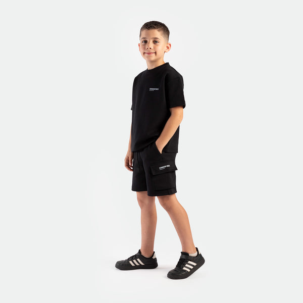a boy young wearing matching set black , t-shirt and short black with tow pocket , plus the shoes black 