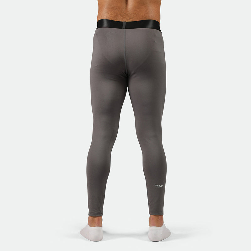 a back view for fit man wearing QUIEST-SHADE-GREY legging with logo plus socks 