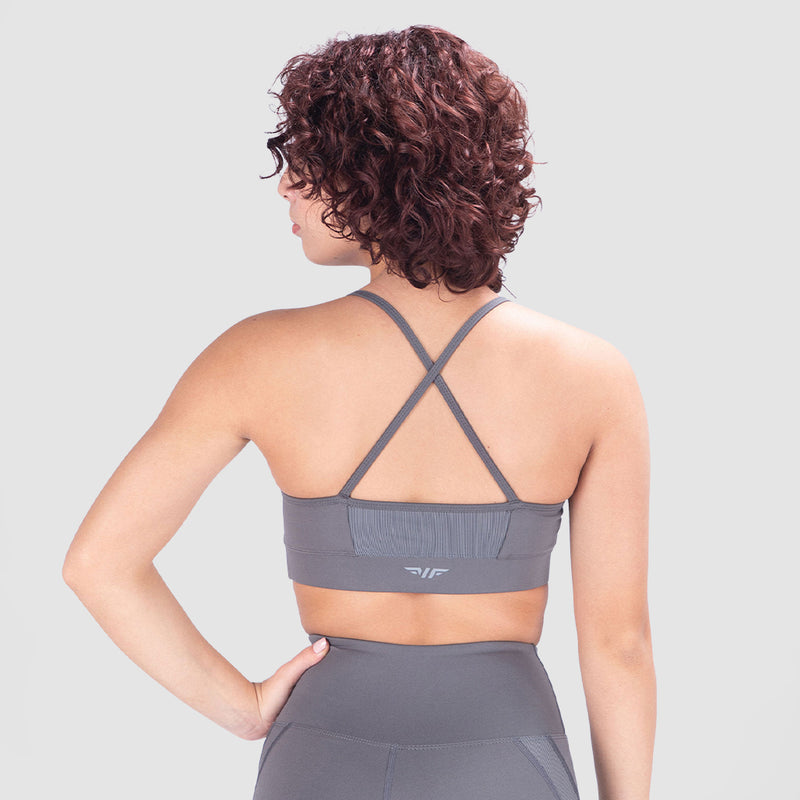a back view for woman wearing  matching  bra and legging , the bra have specials design with logo 