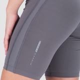 Close-up of someone wearing gray compression shorts with vertical striped detail. The words "Winner Force" are visible, suggesting a sporty, active vibe.