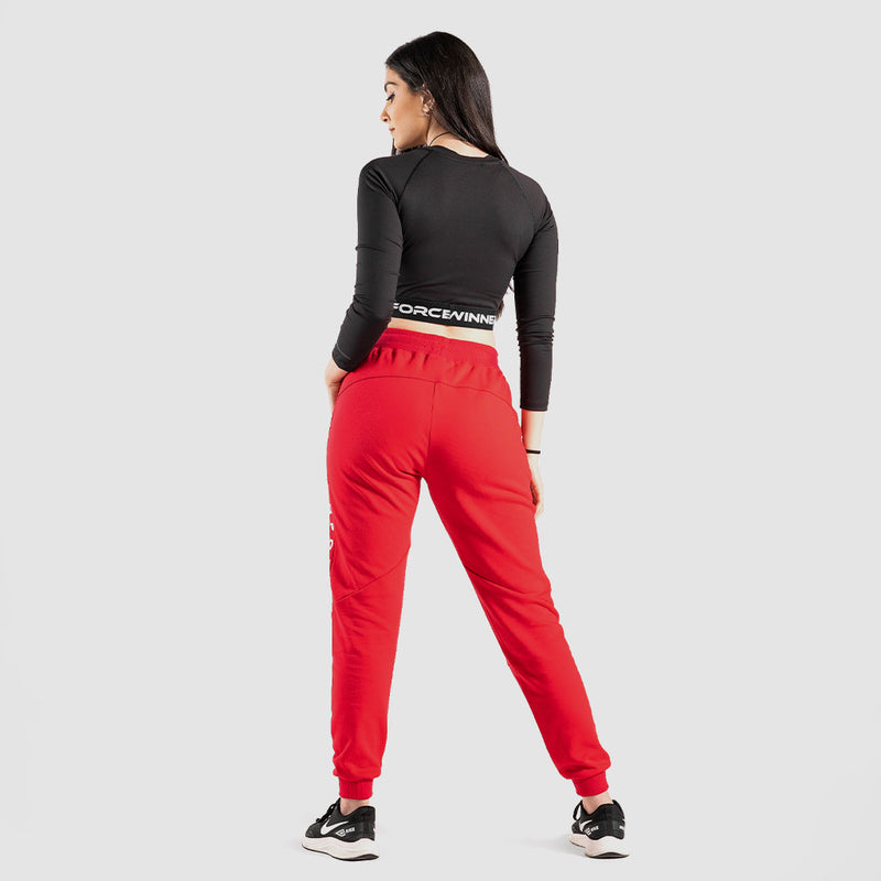 a back view for fit woman wearing crop top black with red jogger pants  and 
shoes black ,plus the background is light grey 