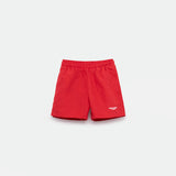 Bright red athletic shorts laid flat on a light background. The shorts have a small white logo on the lower left side and feature a simple, sporty design