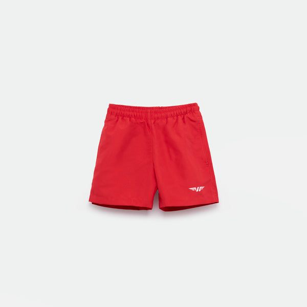 Bright red athletic shorts laid flat on a light background. The shorts have a small white logo on the lower left side and feature a simple, sporty design