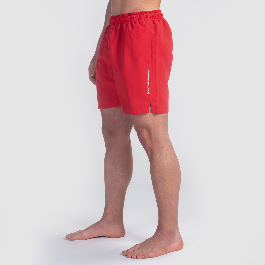 a fit man stand at right and wearing short  red with logo 
