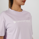close up view for fit woman wearing t-shirt lavender blue with logo 