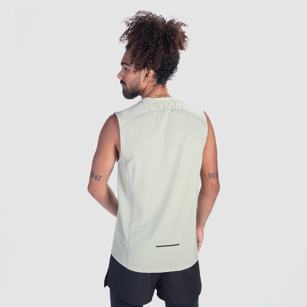 a fit man wearing tank sage green with short black 2 in 1