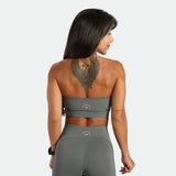 a back view for fit woman wearing matching sage grey ,bra and short 