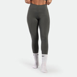 a fit woman wearing legging  sage grey terrazzo with socks white plus the logo 