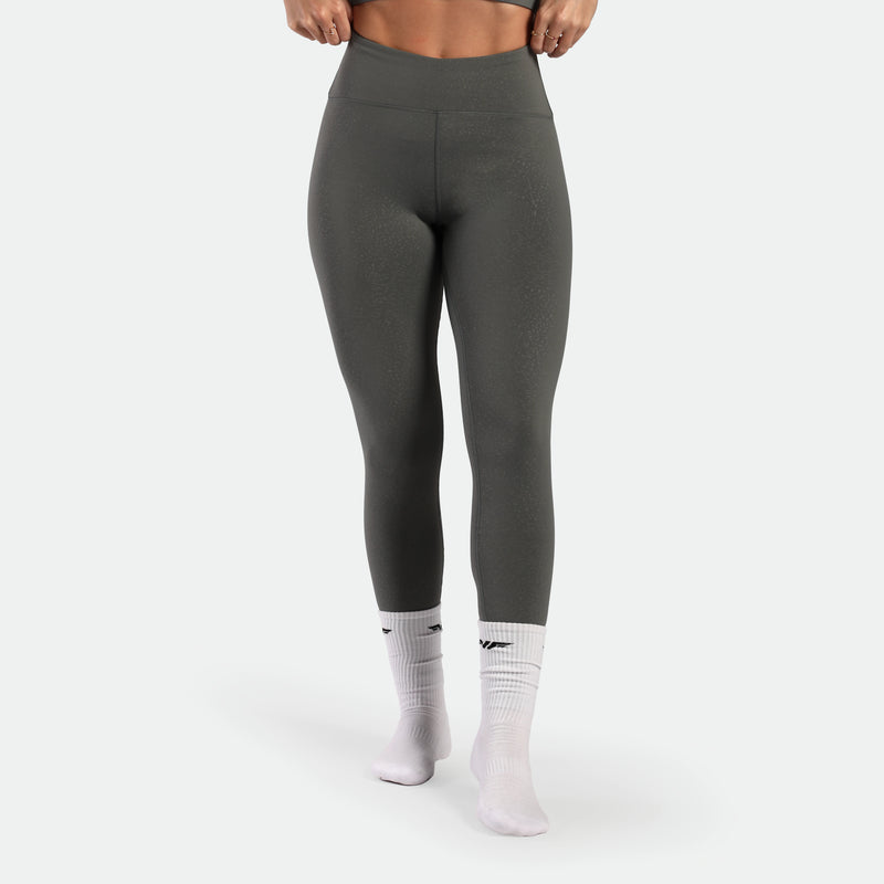 a fit woman wearing legging  sage grey terrazzo with socks white plus the logo 
