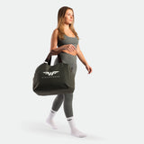 a fit woman wearing matching set sage grey terrazzo, bra and legging ,plus the bag and socks  