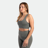 a fit woman  wearing matching set sage grey terrazzo ,bra and legging 