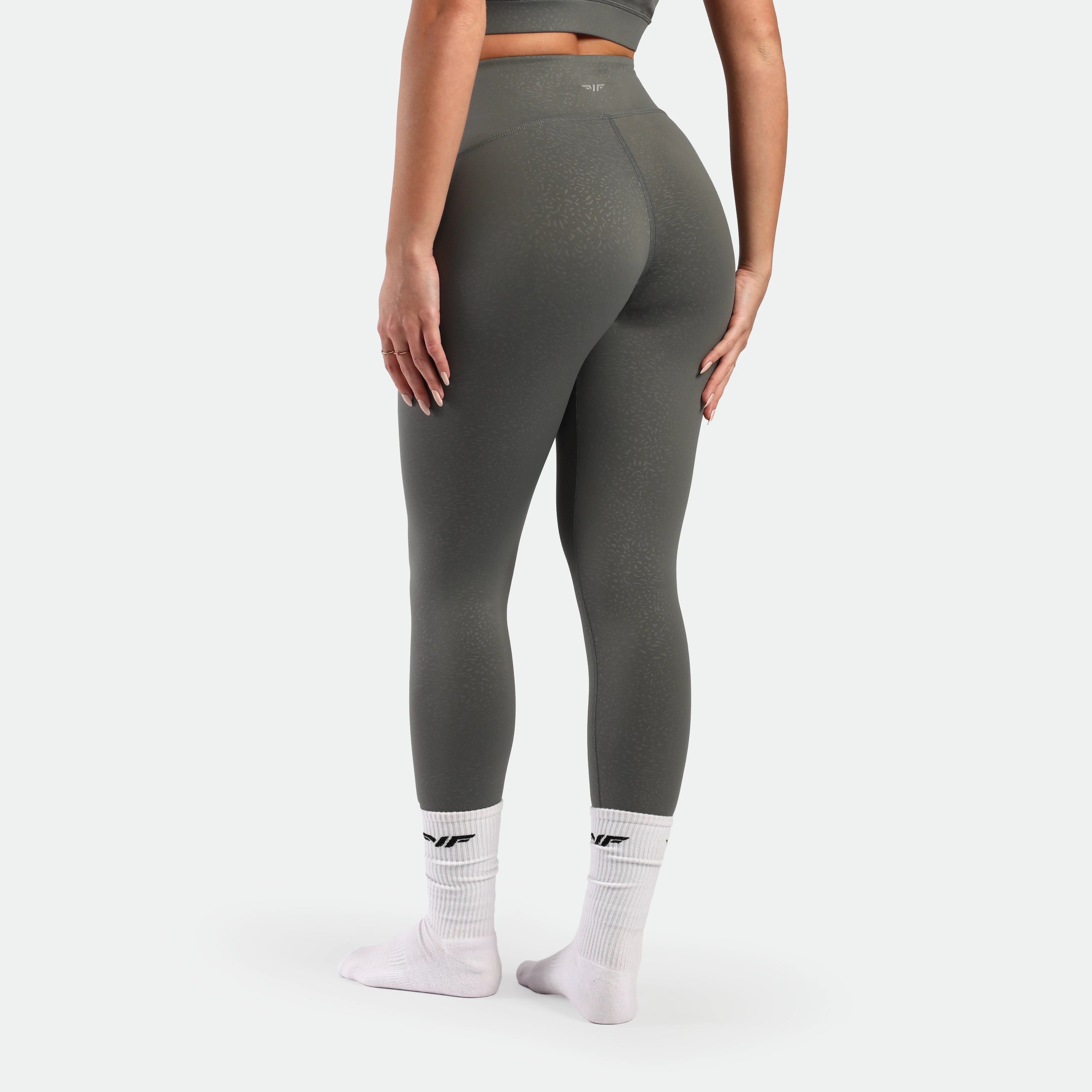 a bac view for fit woman wearing legging sage grey terrazzo socks white 