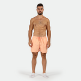 a fit man wearing short SALMON-PINK with socks white 