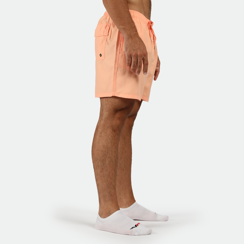 a fit man stand at right and wearing short SALMON-PINK with socks 