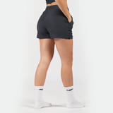 a back view for fit woman wearing short grey with socks white ,plus the background is light grey 