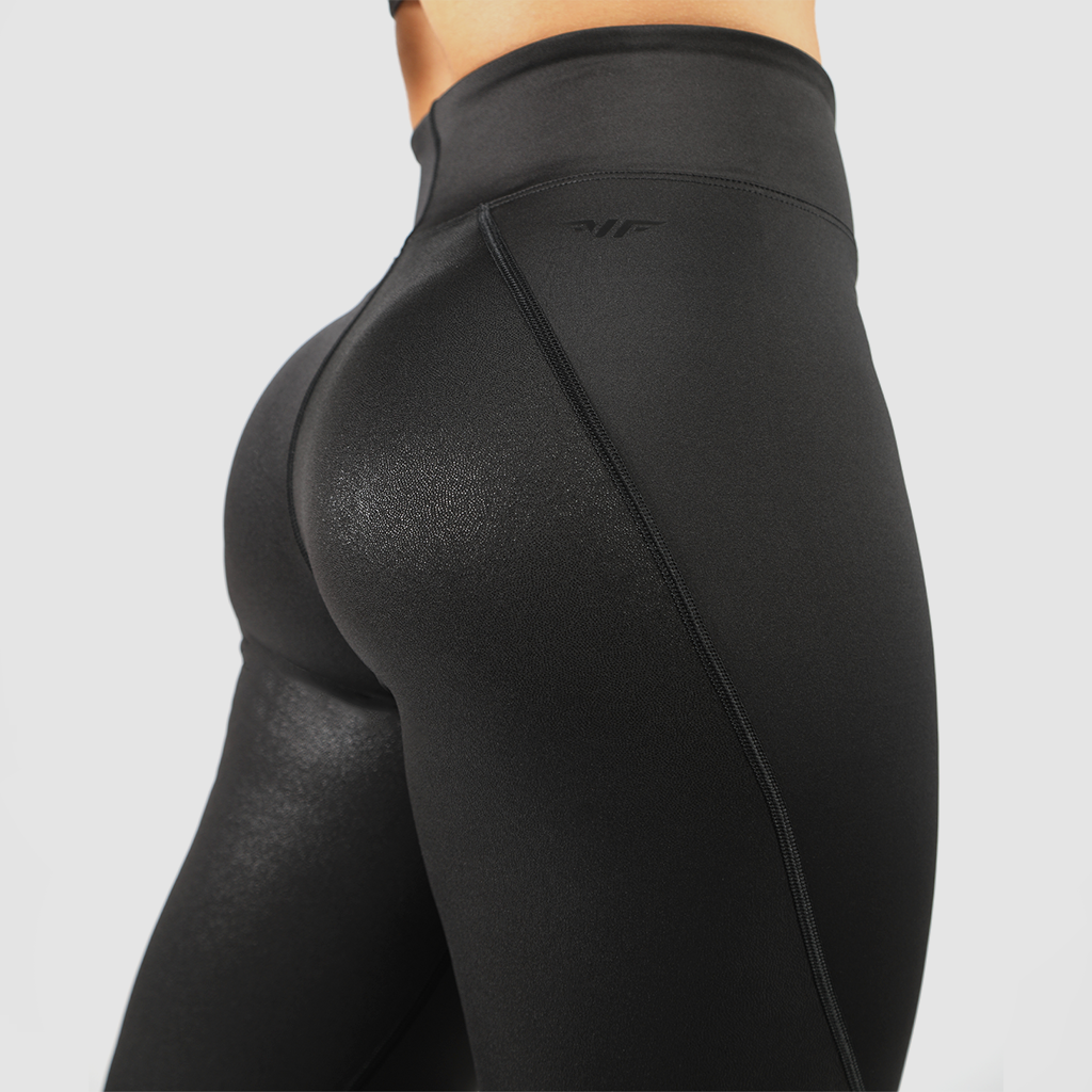 a back view for woman wearing legging black with background light grey 