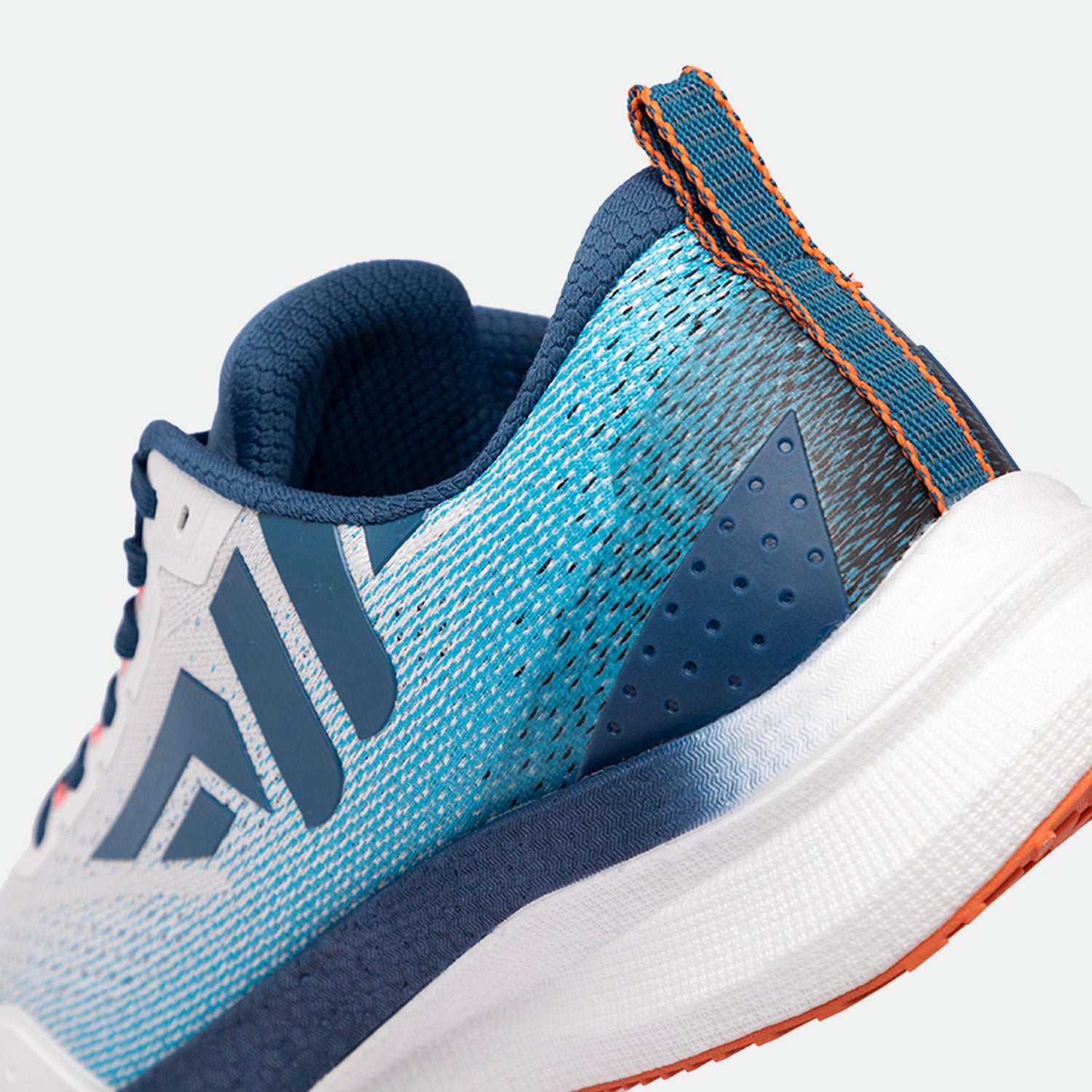 Close-up of a blue and white athletic shoes focusing on the heel. Features include textured fabric, orange stitching, and a sleek, modern design.