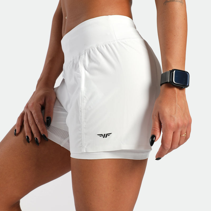 White athletic shorts with a brand logo worn by a person on a white background