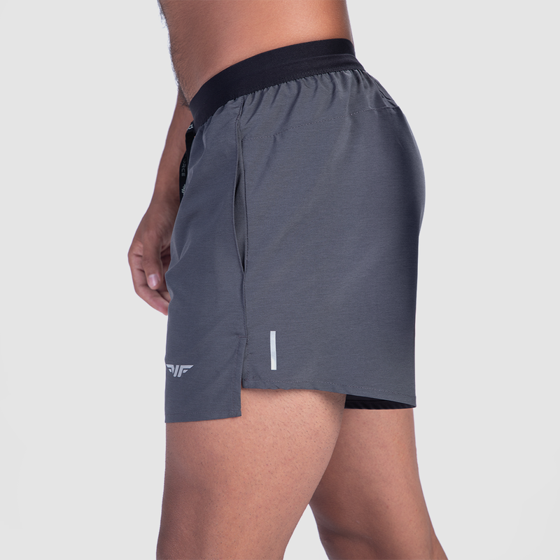 a fit man stand at right and wearing short grey with logo 