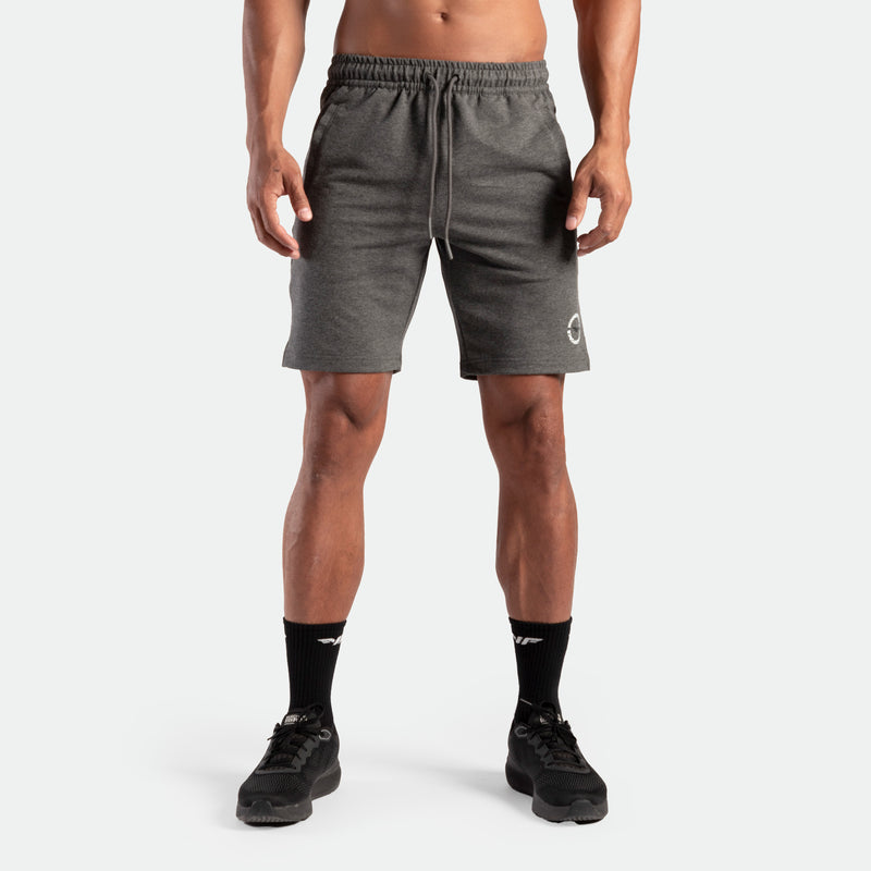a fit man wearing short marl dark grey with logo and lace ,plus the socks and shoes black 