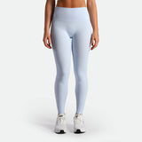 a fit woman wearing legging sky blue  with shoes white 