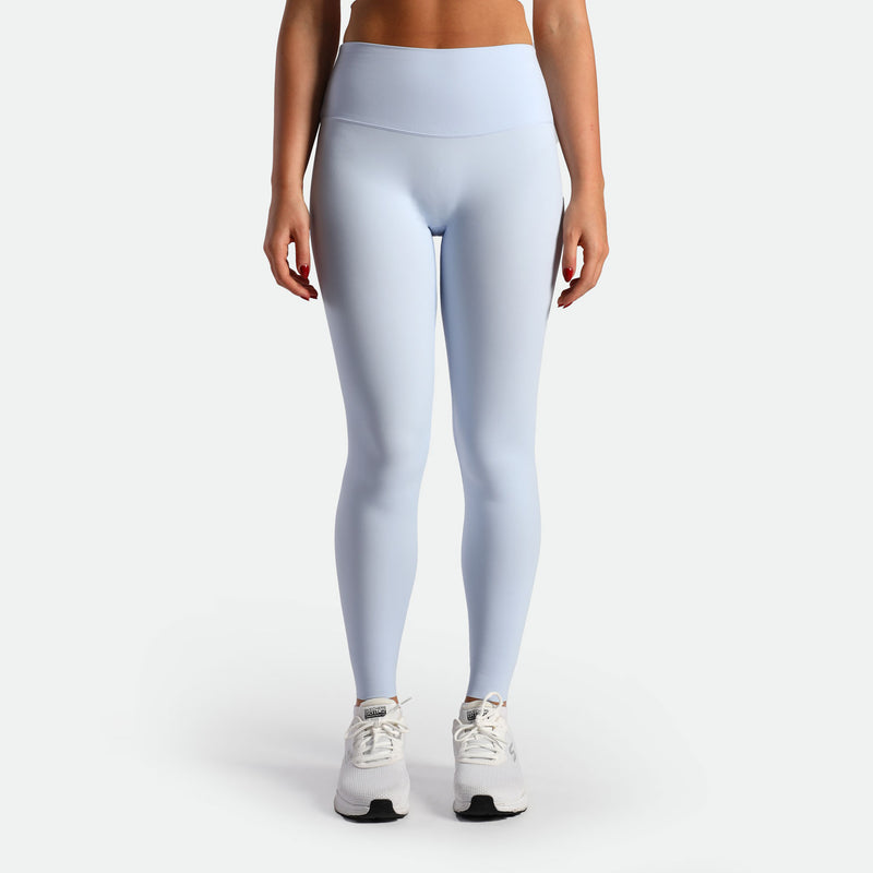 a fit woman wearing legging sky blue  with shoes white 