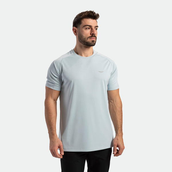 a fit man wearing t-shirt sky blue with pants black 