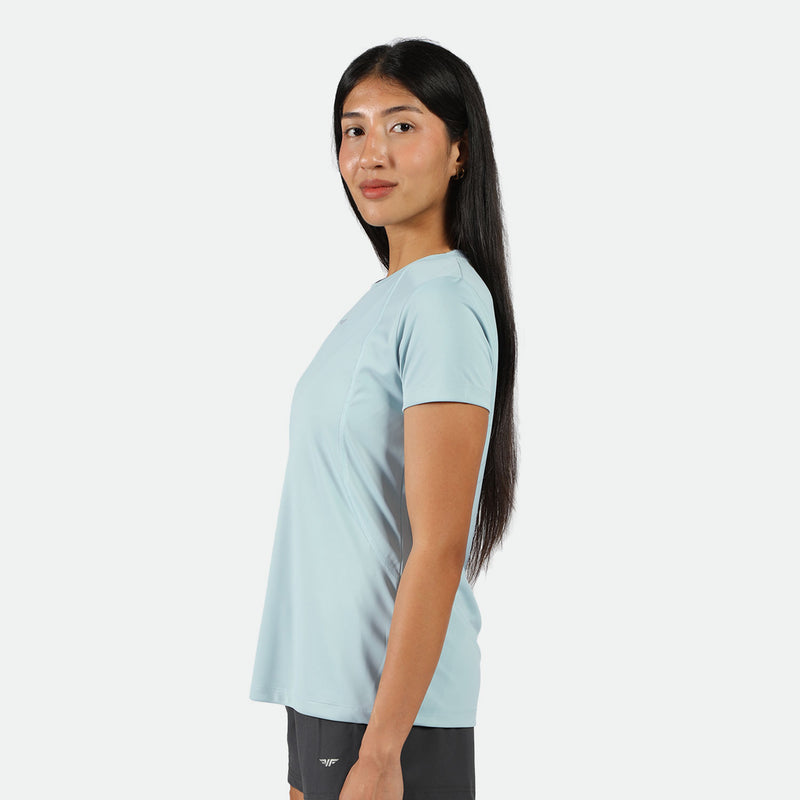 a fit woman stand at right and wearing t-shirt sky blue  with short black