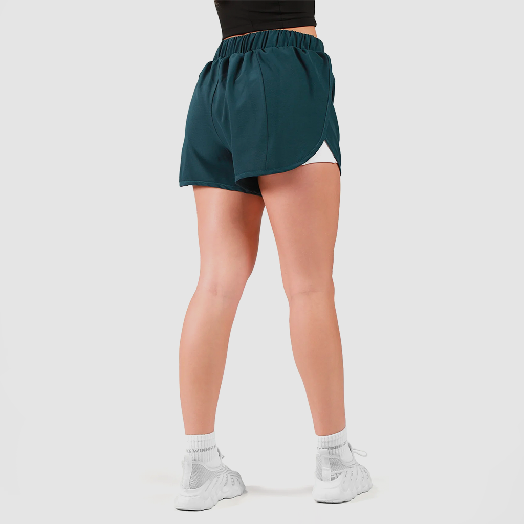 a back view for fit woman wearing 
 stargazer blue  short  2 in 1 with shoes white ,plus the background is light grey 