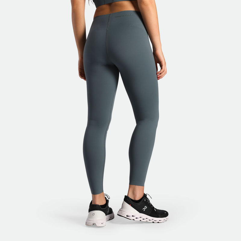 a back view for fit woman wearing legging stormy grey with shoes black 