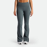 a fit woman wearing flared legging stormy grey  with shoes 