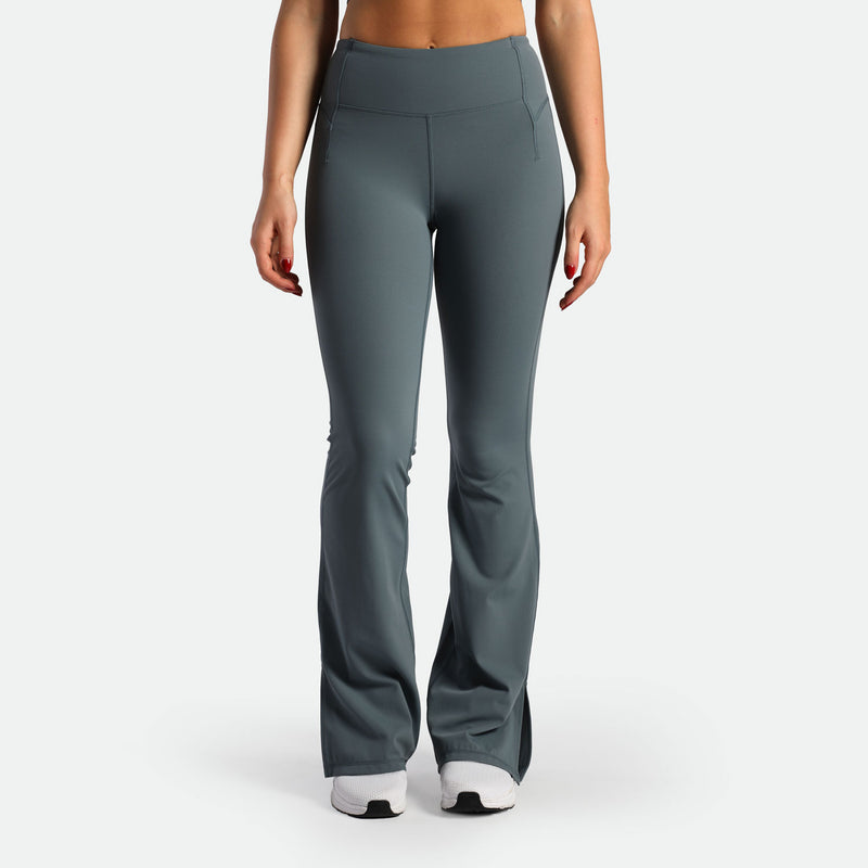 a fit woman wearing flared legging stormy grey  with shoes 