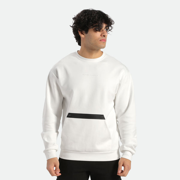 a fit man look at right with curly hair wearing sweatshirt white and pants black 