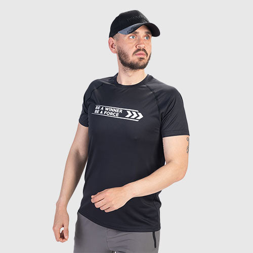 Man wearing a black t-shirt with text and a cap on a light gray background