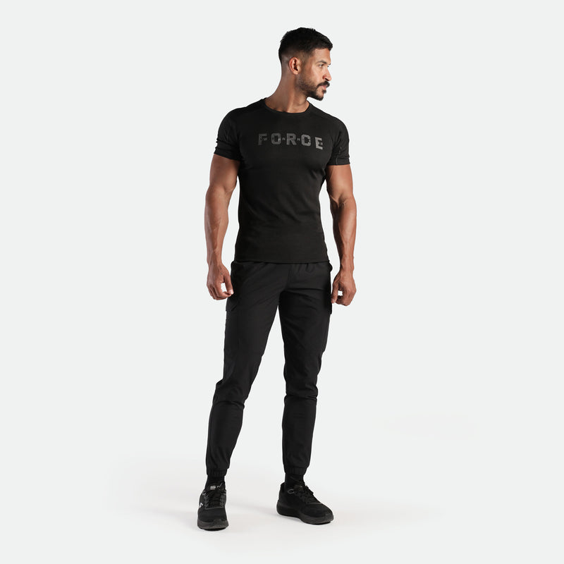 a fit man wearing t-shirt black with logo and pants  black ,plus the shoes  black 