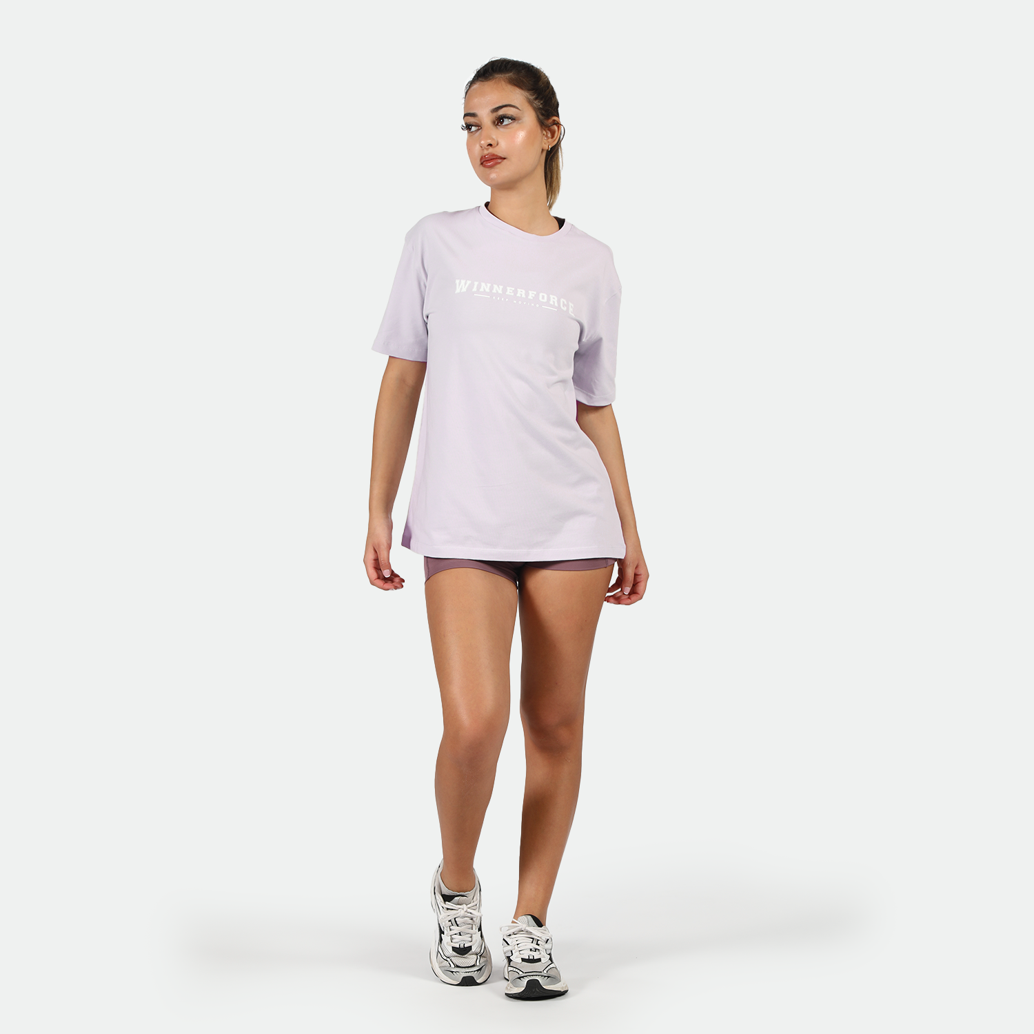 a fit woman stand with pose and wearing t-shirt lavender with short purple and sneakers