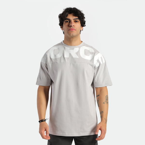 a fit man look at camera ,he wearing t-shirt light grey with logo and pants black 