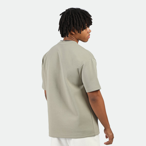 a back view for fit man wearing t-shirt seagrass green with short white 