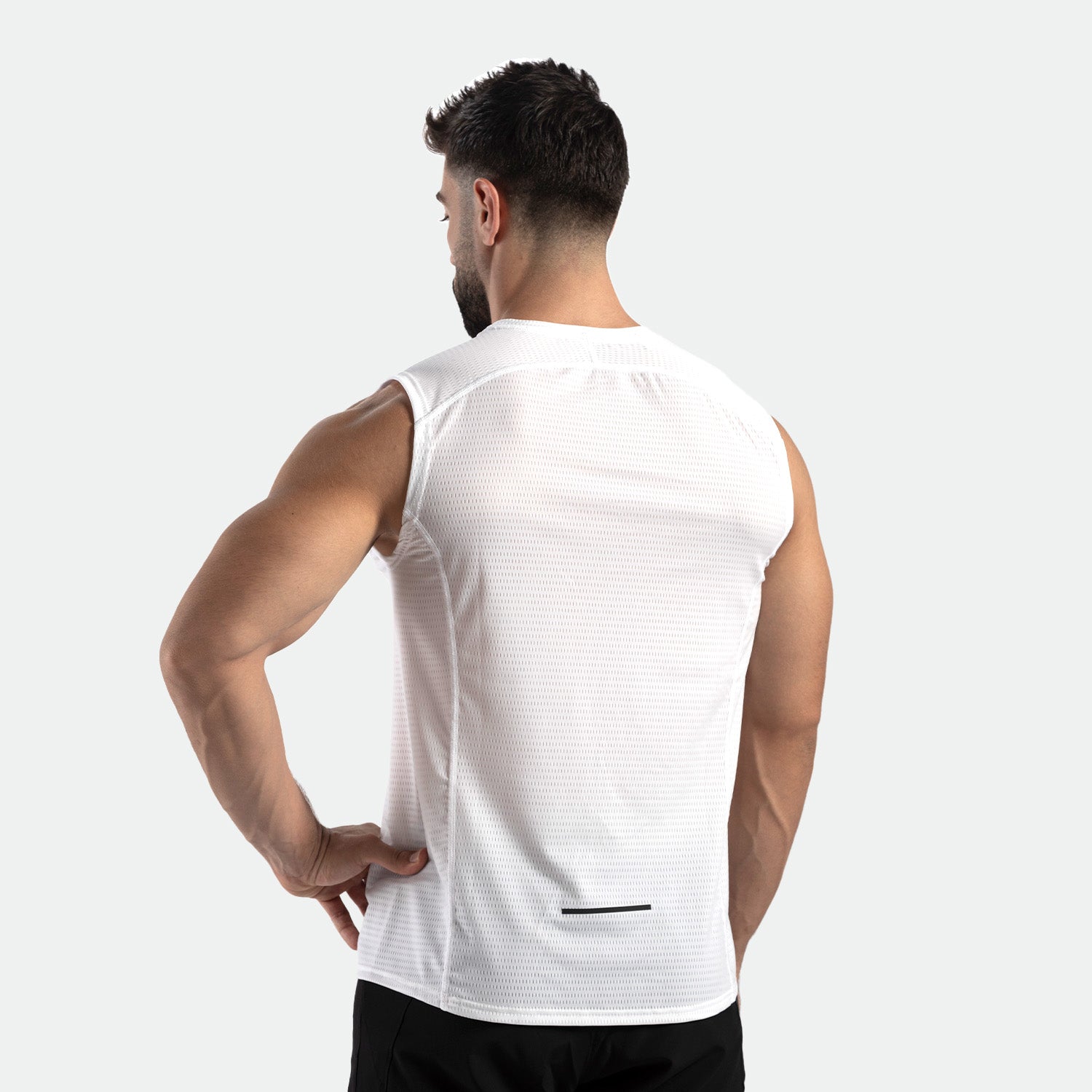 a back view for fit man wearing  t-shirt white with pants black 