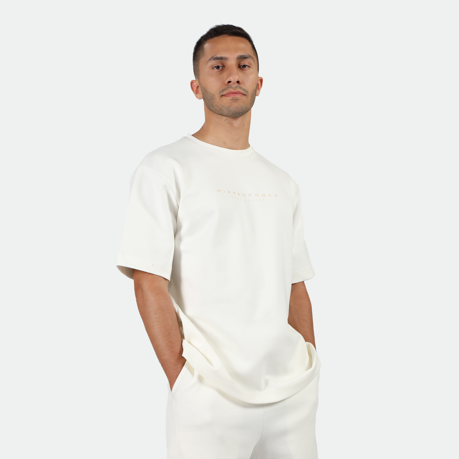 a man wearing matching set off white ,t-shirt and short 
