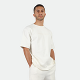 a man wearing matching set off white ,t-shirt and short 