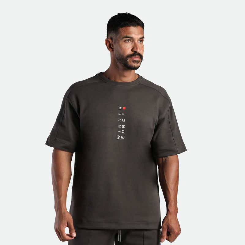 a fit man wearing  matching set iron dark grey ,t-shirt with logo and short 