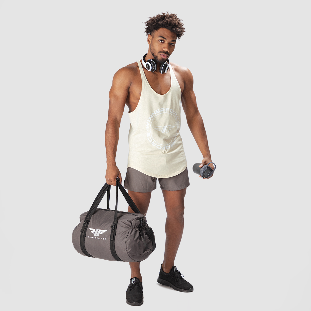 a fit man wearing tank  afterglow with short grey ,plus shoes black 