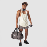 a fit man wearing tank  afterglow with short grey ,plus shoes black 